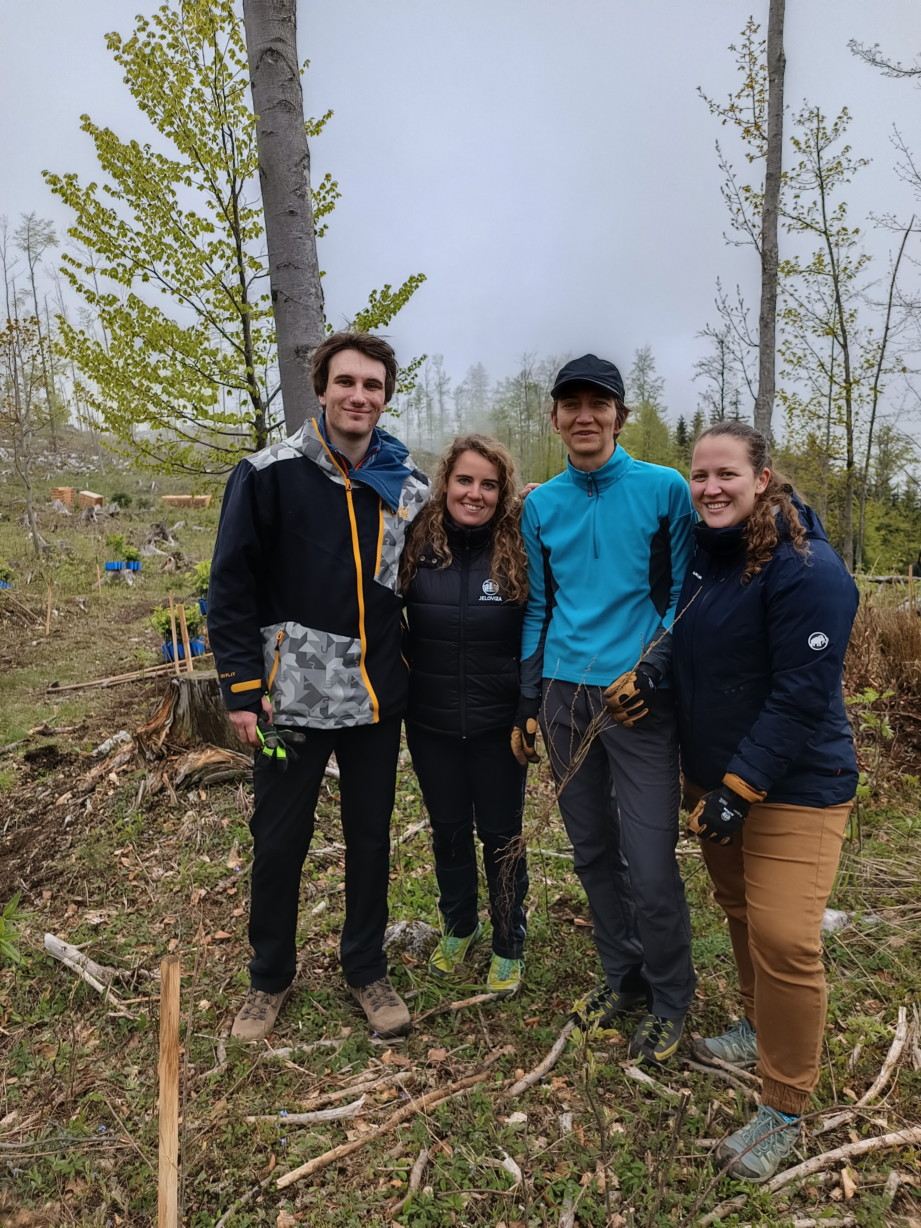 A group of 4 people in the middle of the forest.