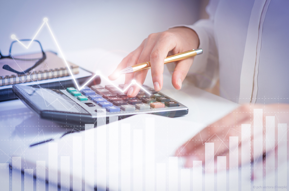 Accountant calculating profit with financial analysis graphs. Notebook, glasses and calculator lying on desk. Accountancy concept. Cropped view.