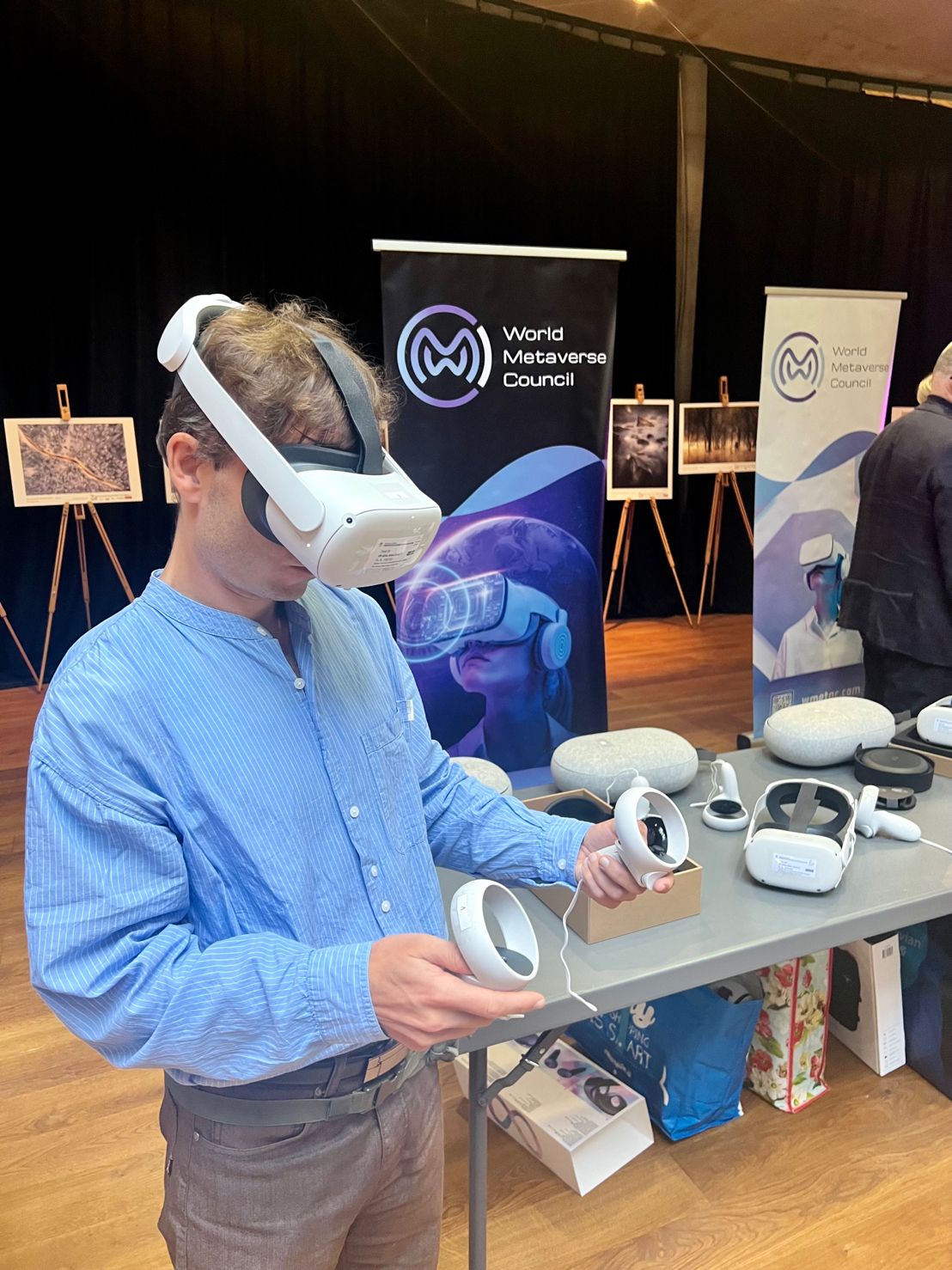 Moški z očali za virtualni resničnost, v rokah drži pripomočke za očala