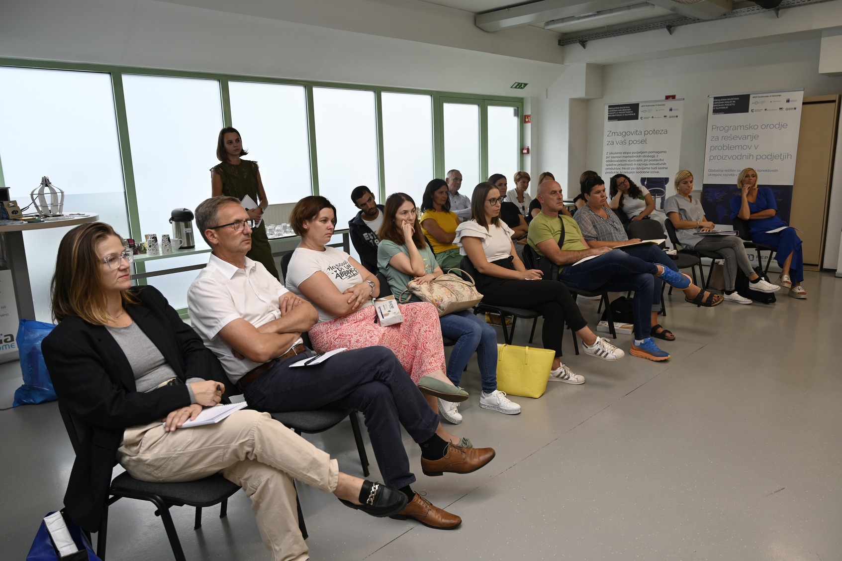 A group of listeners sitting on chairs