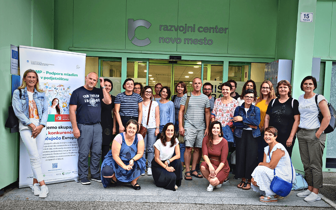 Event participants in front of the building, with a roll-ip next to it