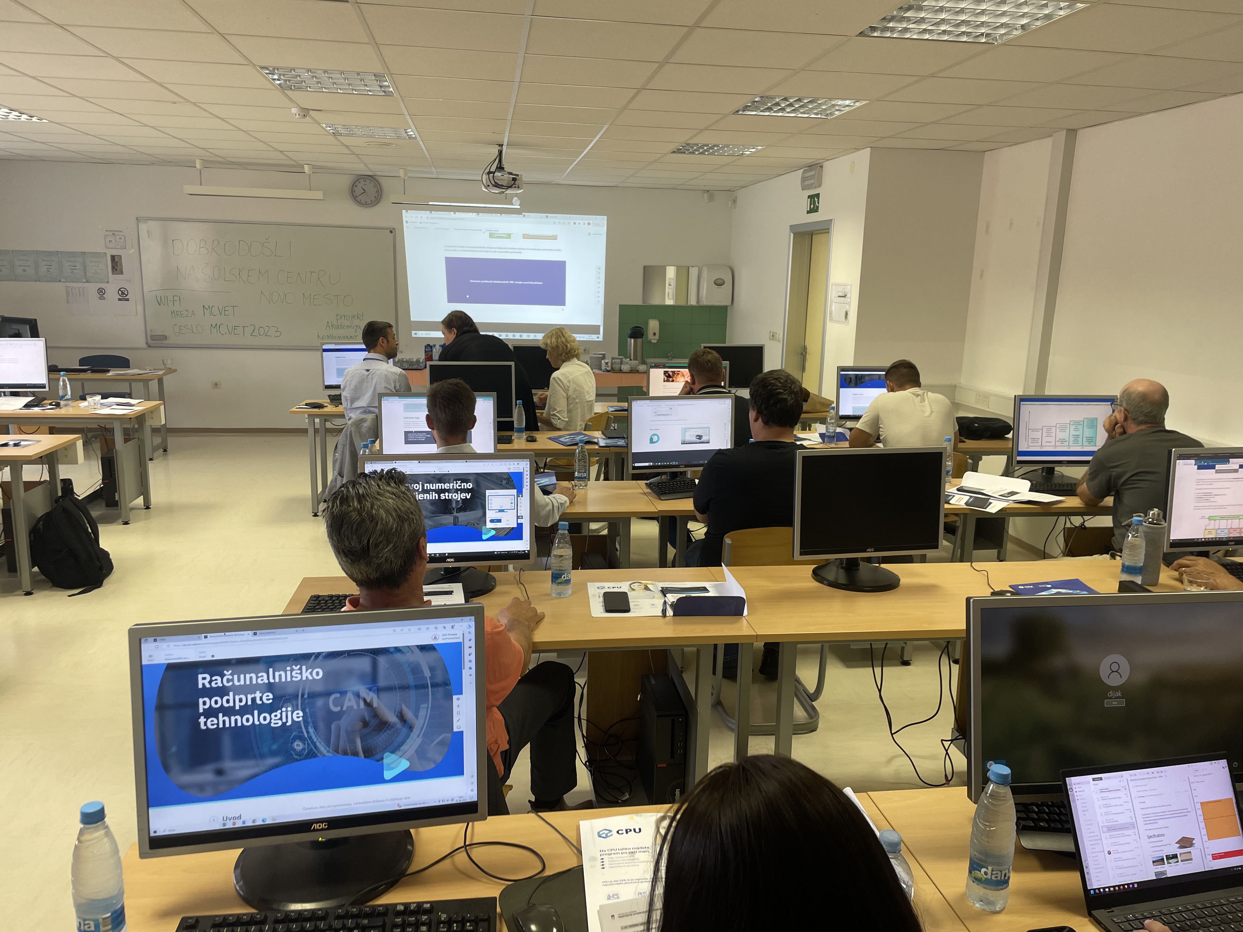 A classroom, with computers on every desk.