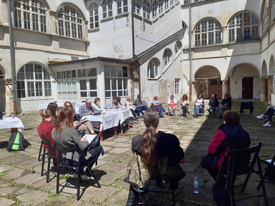 a group of people sitting in a circle in the castle courtyard