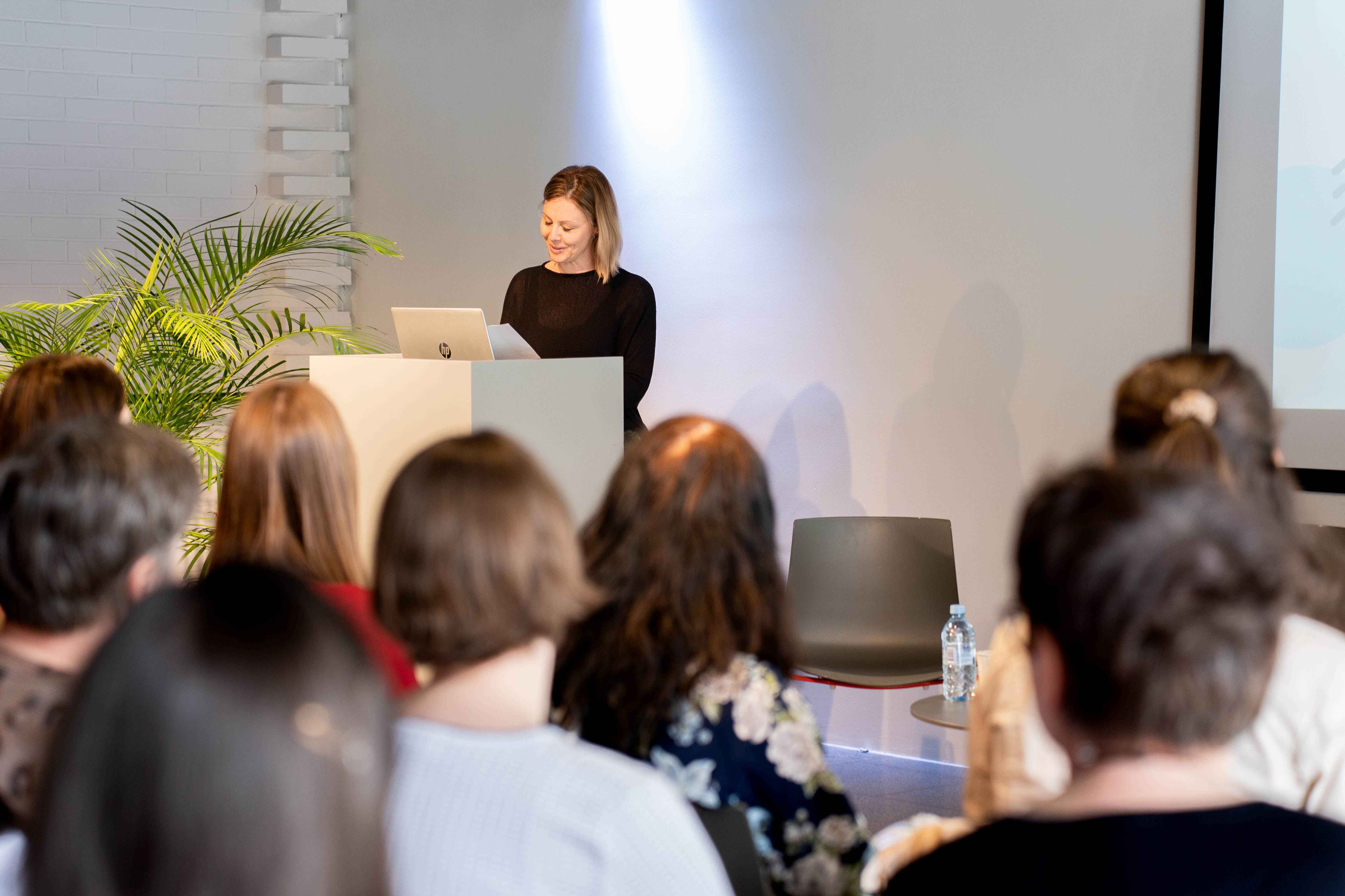 Participants listen to a speaker.