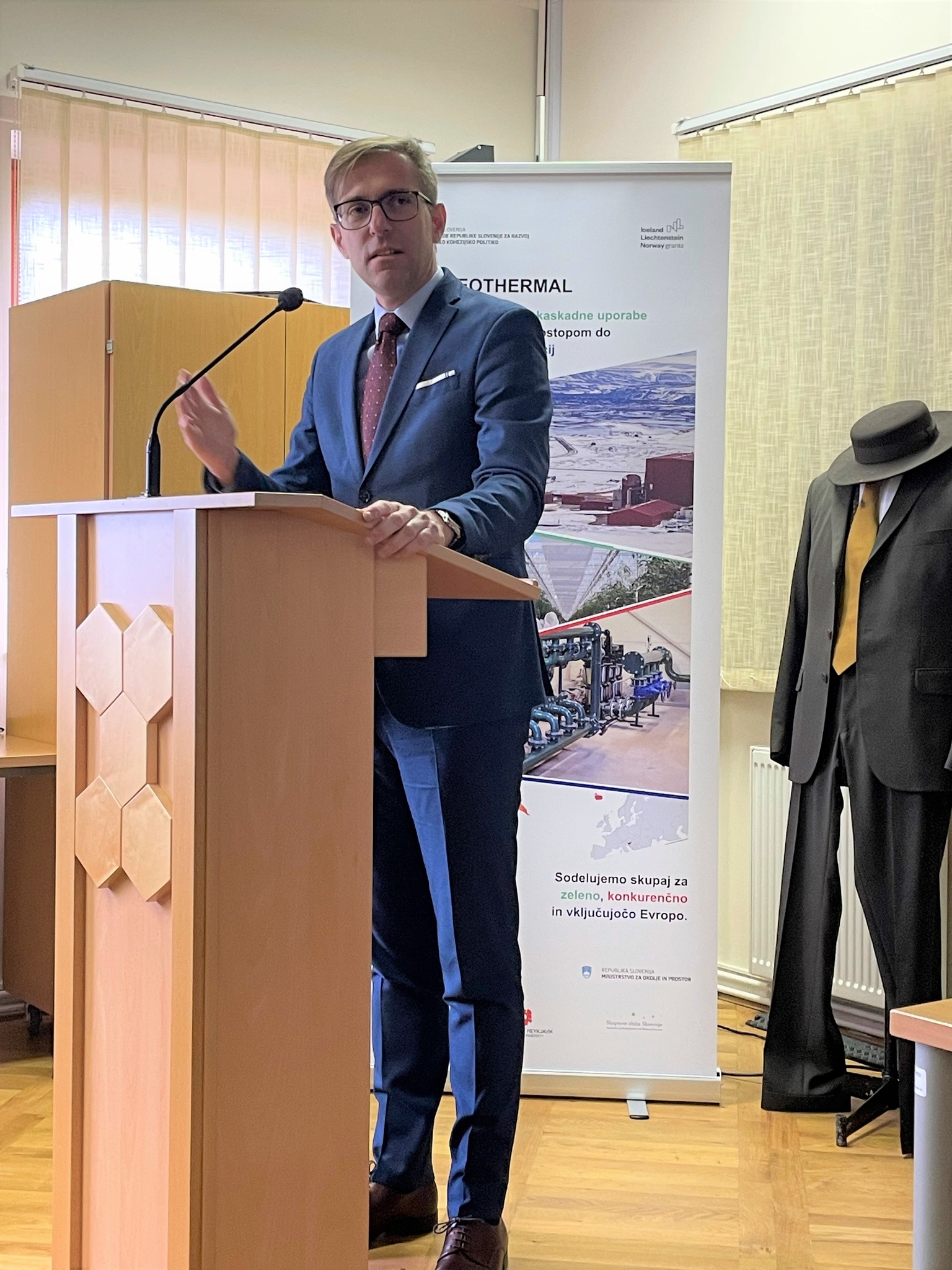 State Secretary at the Ministry of Cohesion and Regional Development, mag. Marko Koprivc, standing behind a microphone during the opening speech.